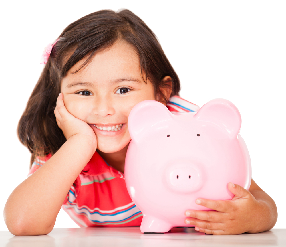 Little girl saving money in a piggybank - isolated over a white background