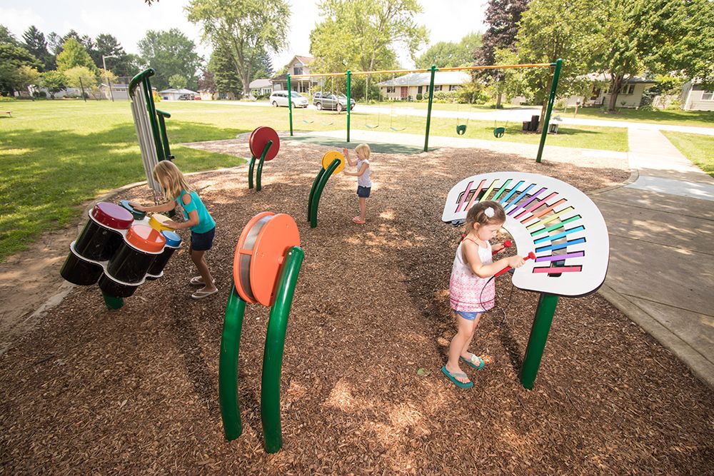 Children playing on a playground with equipment geared for sensory learning