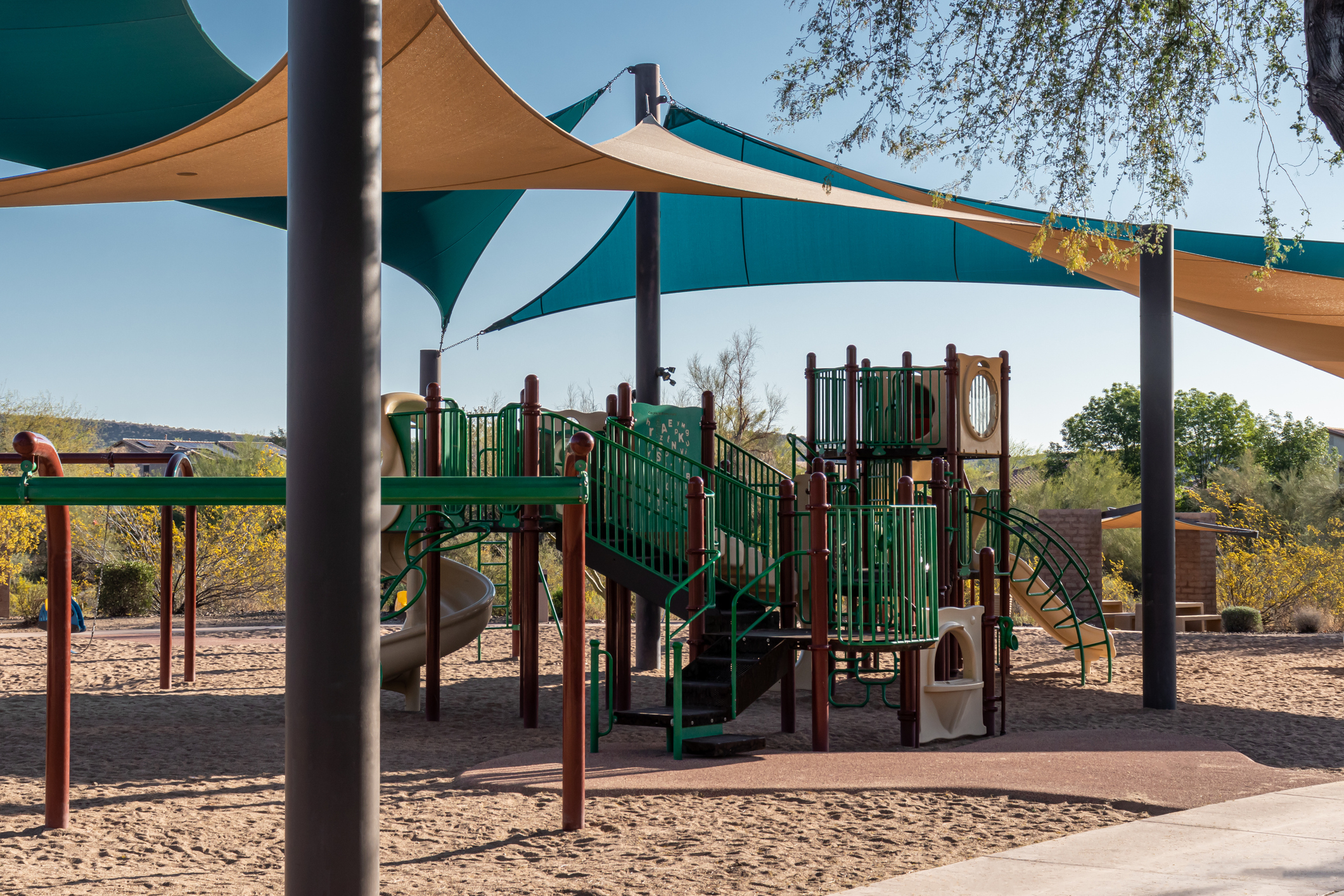 Tan and teal colored shade structure on playground